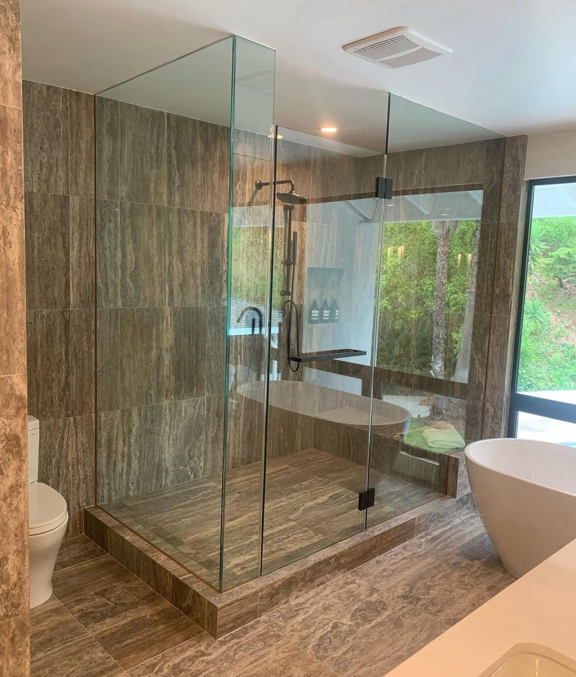 Modern walk-in shower with frameless glass panels